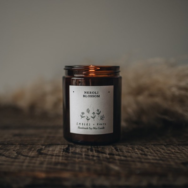 Neroli Blossom soy candle on a weathered wooden surface